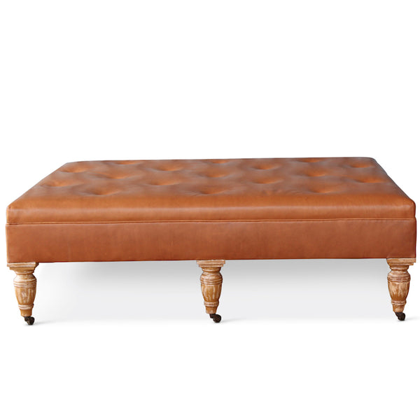Our Garner Ottoman, designed by Hollywood at Home founder Peter Dunham, features turned wood legs in various finishes, with an upholstered top & button-tufted details. This piece is available COM.