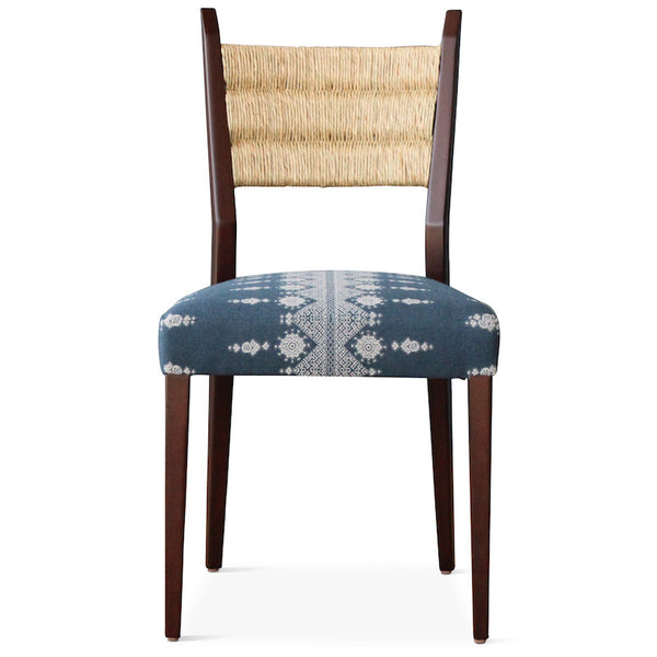 Our Silverlake side chair, designed by Hollywood at Home founder Peter Duhham, is handmade in Los Angeles with a solid oak frame, a handwoven rush back, and an upholstered seat. The dining chair adds vintage style to a dining area. 