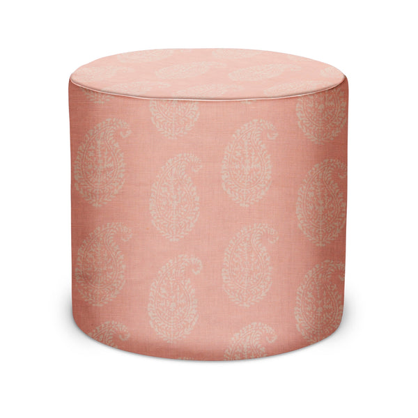 Indoor pouf with pink cylinder cover and pale paisley pattern, round top