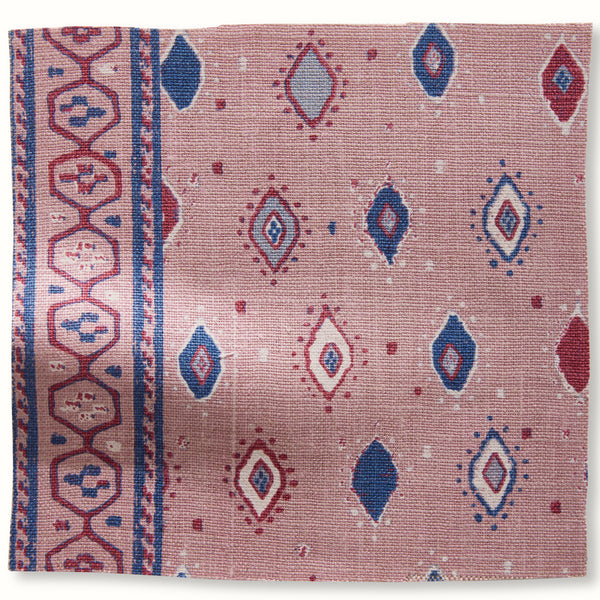 Pillow cover in pale pink with indigo geometric diamond and oval pattern border
