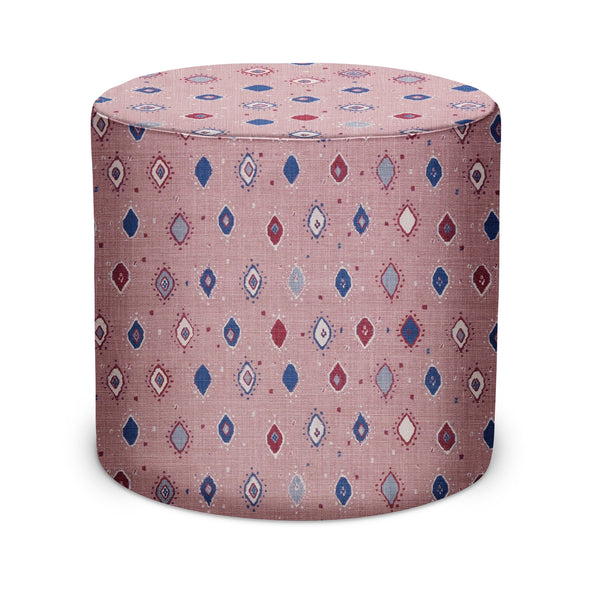 Indoor pouf with pale pink fabric and indigo geometric diamond pattern, rounded cylindrical top