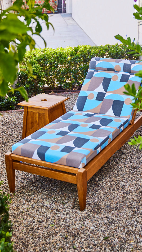 Indoor/outdoor Formosa chaise lounge with blue geometric cushion set and wood base
