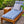 Indoor/outdoor Formosa chaise lounge with blue striped cushion set and wood frame