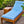 Indoor/outdoor Formosa chaise lounge with blue textured cushion and wood frame