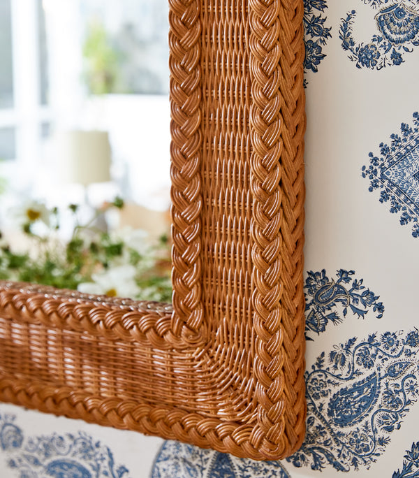 Rectangular wicker mirror with braided brown frame and woven corner detail
