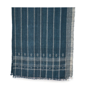 Indigo bedcover with vertical stripes, diamond motifs near hem, fringed border