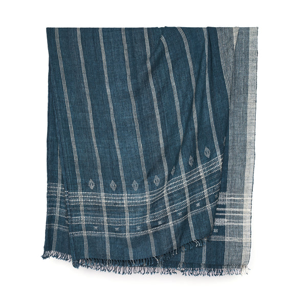 Indigo bedcover with vertical stripe weave and small motif border, fringed edges