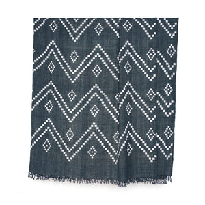 Charcoal bedcover with geometric zigzag motifs and tassel fringe border