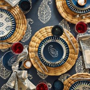 Indigo blue appetizer plate with centered white motif, shown with matching plates