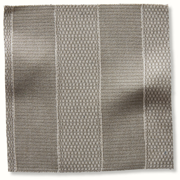 Outdoor patchwork pillow cover in stone with woven geometric grid design