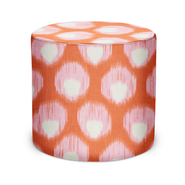 Indoor cylindrical pouf in pink and orange with white ikat-style pattern