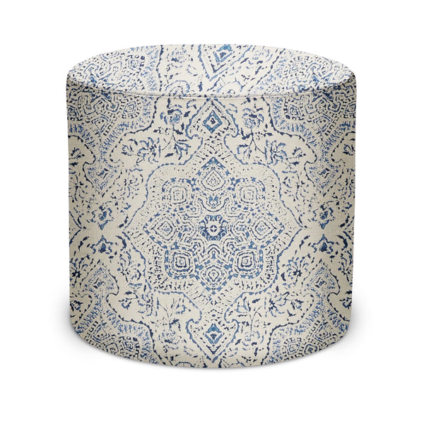 Indoor fabric pouf with blue geometric medallion pattern on light base, rounded top