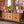 Wicker credenza cabinet with rattan door fronts, drawers, and metal legs