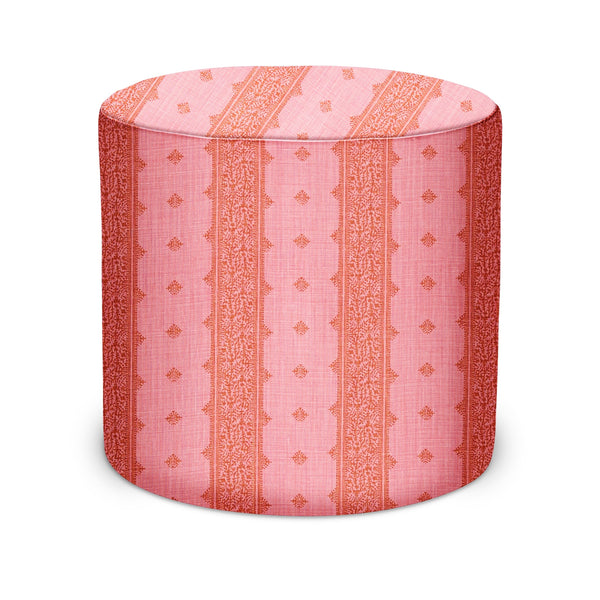 Indoor pouf with pink-and-orange striped fabric, round cylinder design