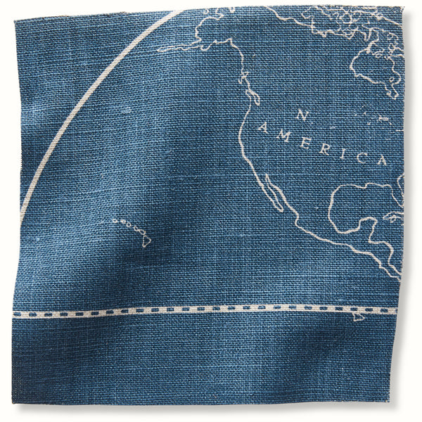 Indigo globe map pillow cover with white line art and stitched border