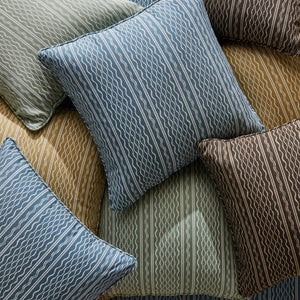 Outdoor throw pillows with vertical wavy stripe pattern in muted blues and greens