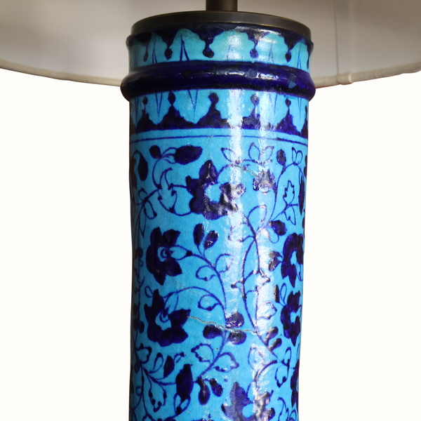 Blue Persian pottery lamp body with dark rim and metal neck under white shade