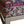 Lexington ottoman close-up of rug-pattern trim with purple border and bead detail