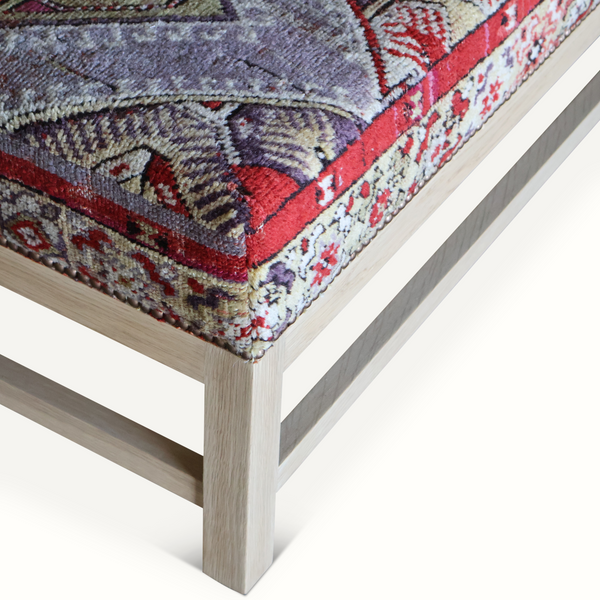 Lexington ottoman corner with rug-pattern upholstery and sturdy light wood base