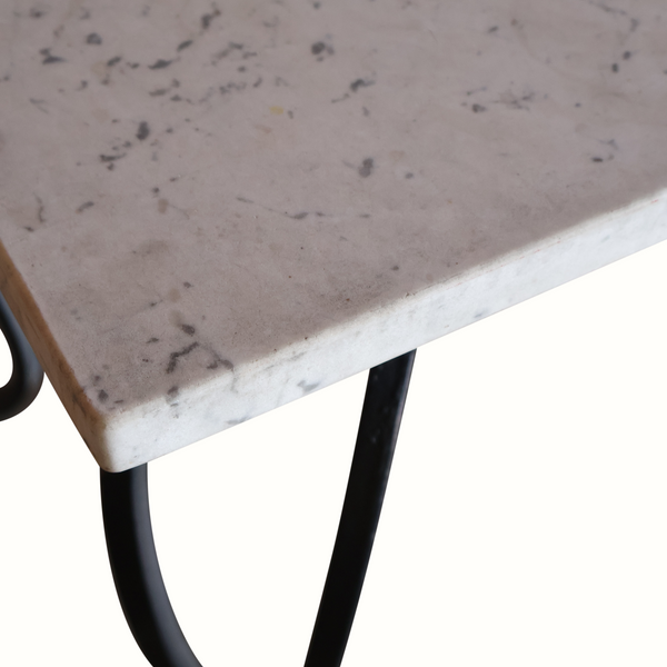 Marble tabletop edge on wrought iron frame with curved black leg