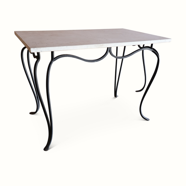 Marble-top wrought iron table with curved black legs and decorative scroll support