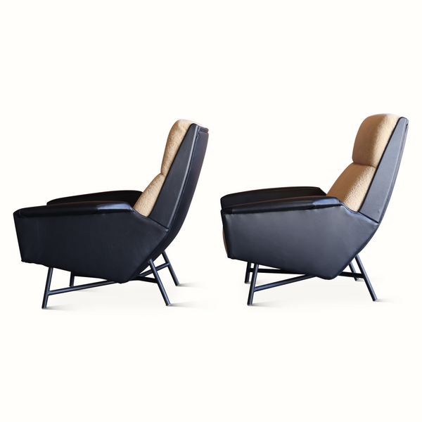 Lounge chair pair with dark blue leather seats and light beige sheepskin backs, angled view