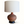 Pottery table lamp with round brown base and carved relief pattern, tan fabric shade