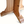 Pine bistro table base close-up with pedestal legs and wide foot crossbar, light wood.
