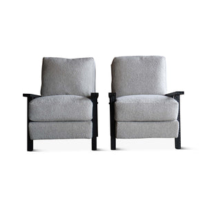 Pair of boucle armchairs with light gray seats and backs and dark wood arm supports