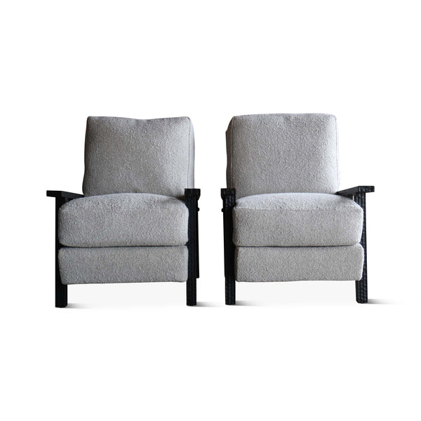 Pair of boucle armchairs with light gray seats and backs and dark wood arm supports