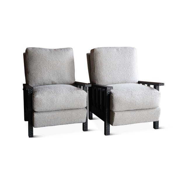 Pair of boucle armchairs with light gray upholstery, dark wood arms, and thick seat cushions