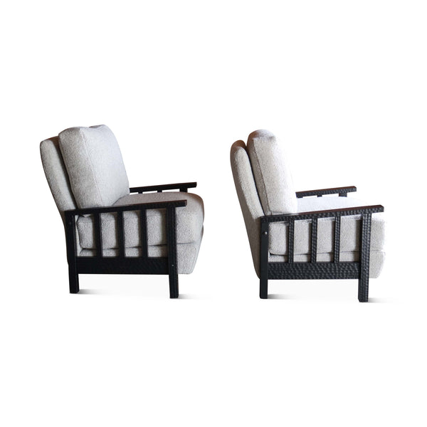 Pair of boucle armchairs with dark wood lattice backrests and light gray seat cushions