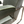 Reclining chair arm and back corner with contrast green piping and chrome support