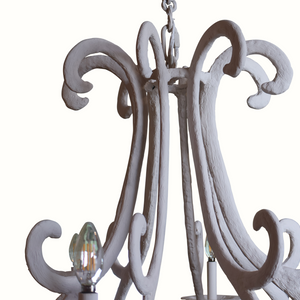 Close-up white gesso-plaster iron chandelier top with chain and curved scroll arms