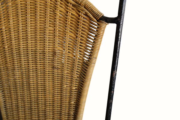 Wicker chair back close-up showing woven texture and dark iron support