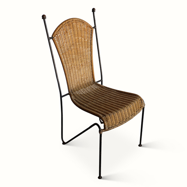 Wicker chair with dark iron frame, arched back and woven seat with curved edge