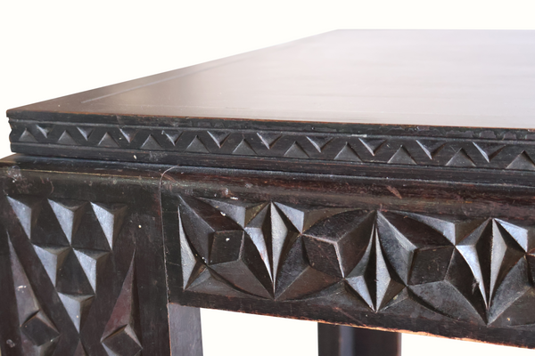 Antique Moroccan table corner with carved geometric trim along the tabletop edge