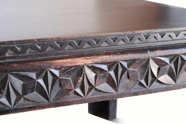 Antique Moroccan table edge close-up with carved triangle and diamond pattern