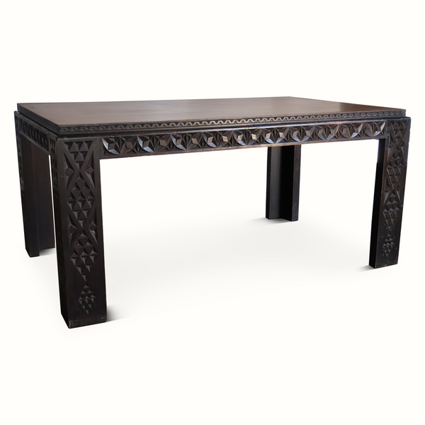 Antique Moroccan table front view with dark carved apron and geometric leg panels