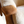 Oak armchair armrest with light sheepskin seat cushion and visible wood grain
