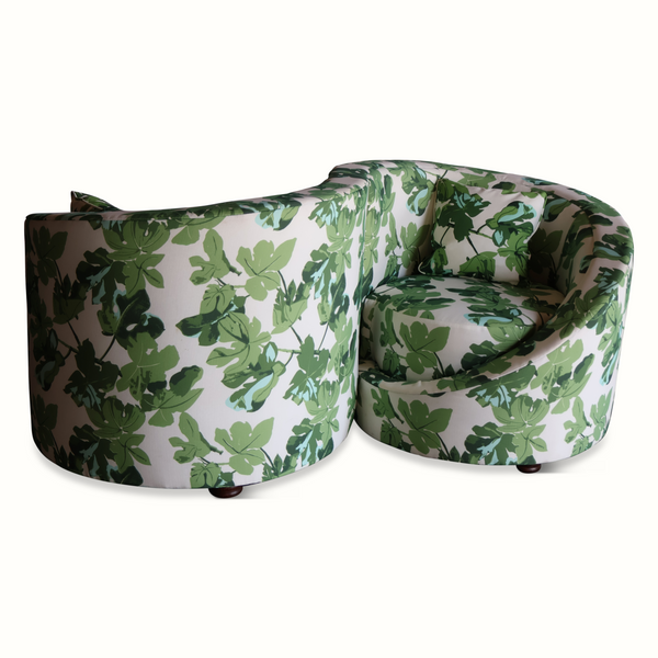 Loveseat sofa with green fig-leaf print fabric, rounded corner shape and short legs
