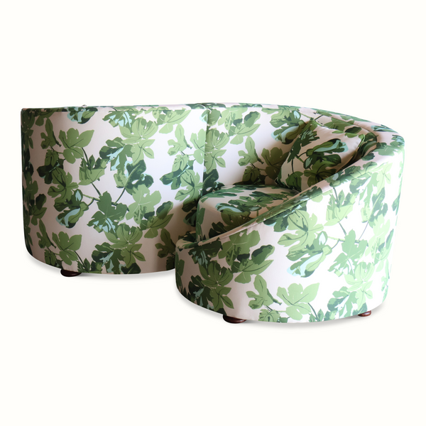Loveseat sofa with leaf-pattern upholstery, curved profile and supportive armrest