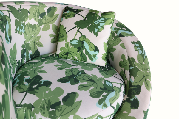 Loveseat sofa with leaf-pattern cushions and two matching back pillows