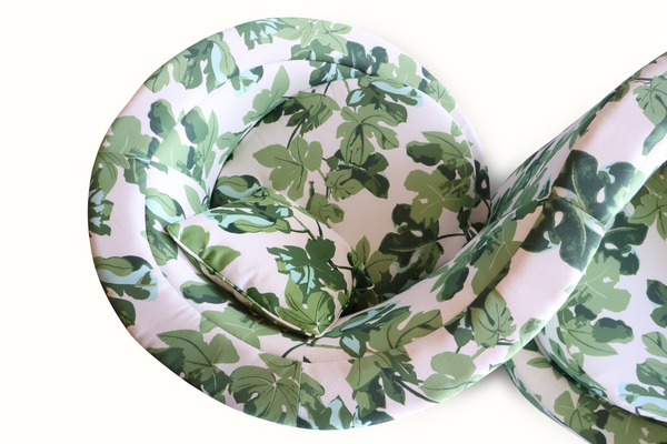 Loveseat sofa interior view with fig-leaf printed cushions and folded armrest