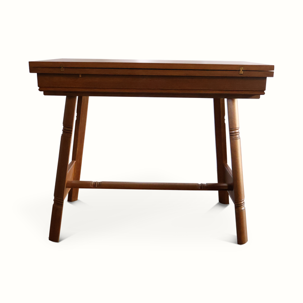 Oak flip-top game table, dark wood finish, with folded legs and underside support bar.