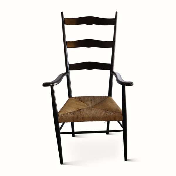 Rush armchair with black frame, wavy back slats, and woven brown seat cushion