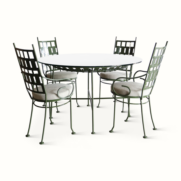 Outdoor patio set with round green metal table and four matching lattice chairs