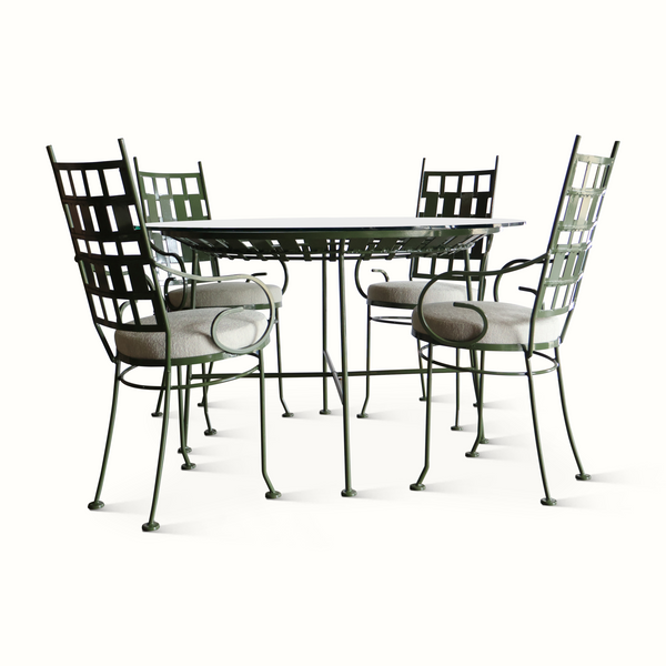 Patio dining set with round green table and four cushioned lattice chairs