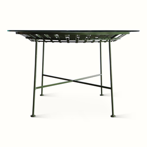 Green metal patio table with slatted top and cross-brace support base