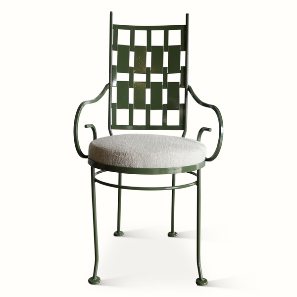 Green metal patio chair with lattice back and round cushioned seat in light gray